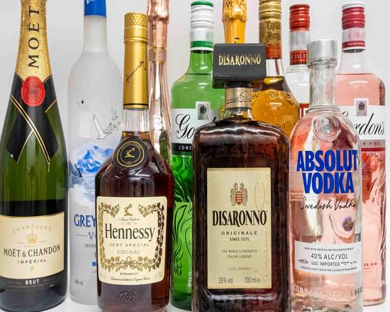 A selection of popular liquor bottles, including Moët & Chandon champagne, Grey Goose vodka, Hennessy cognac, Disaronno amaretto, Absolut vodka, and Gordon's gin.